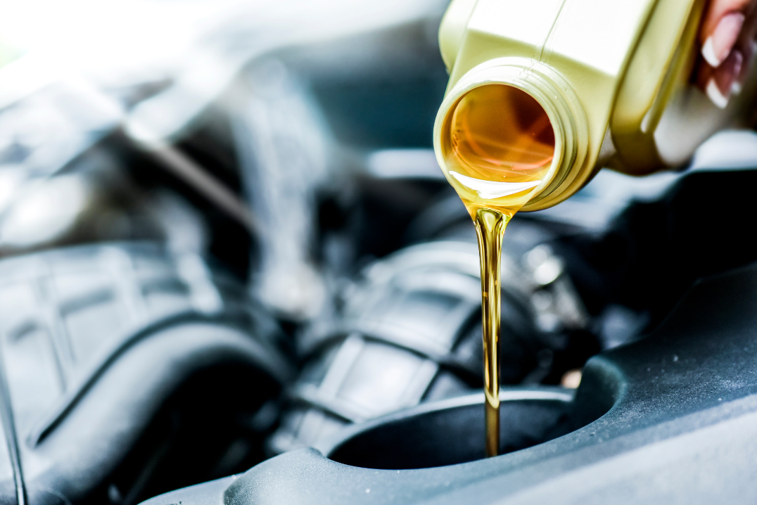 oil being poured into car for oil change