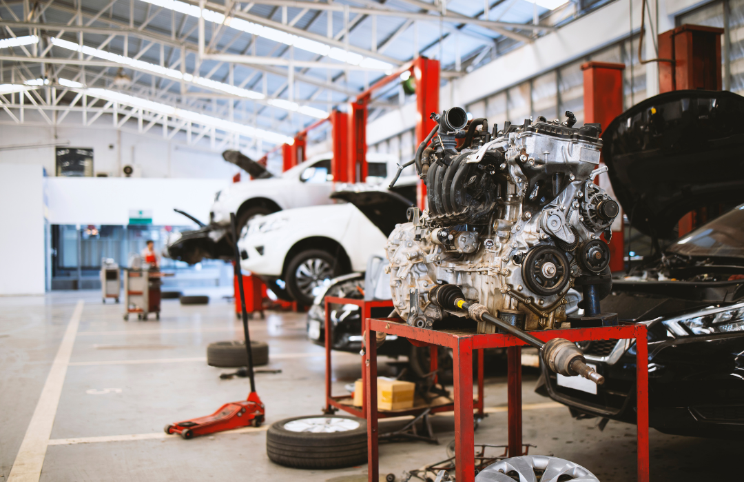 engine block sitting on stand in car dealership auto maintenance station